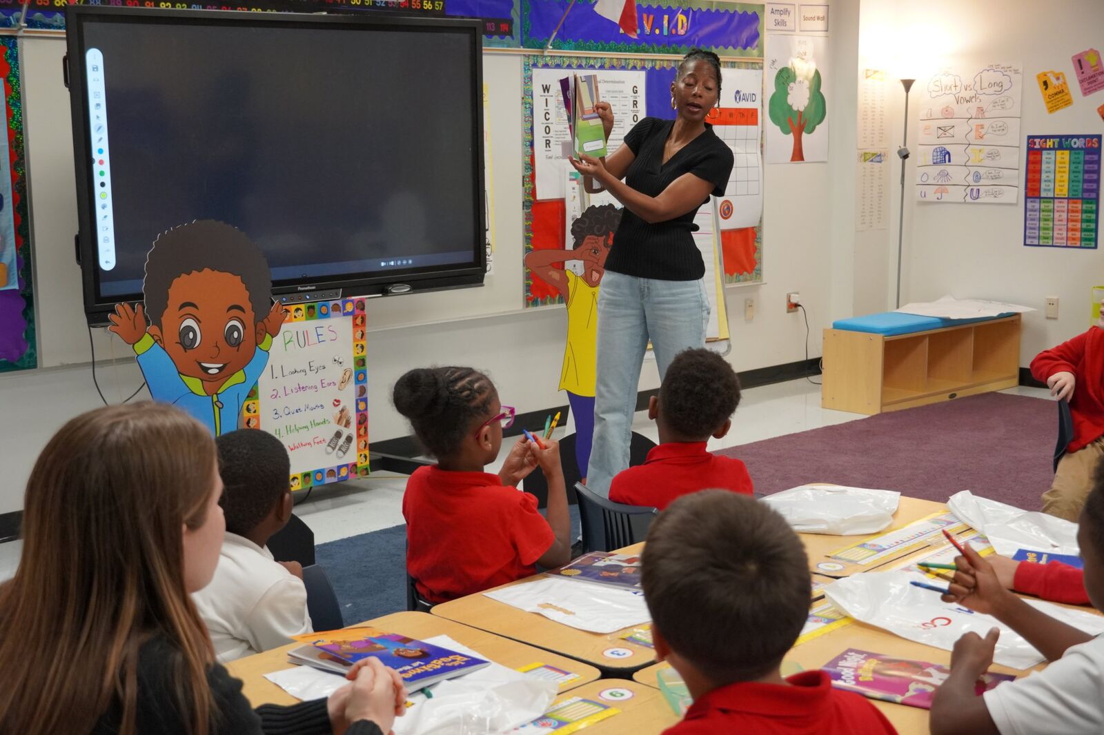 Sharon Jones-Scaife reading a Lil’ Marco and Friends book to students at Frank Guzick Elementary
