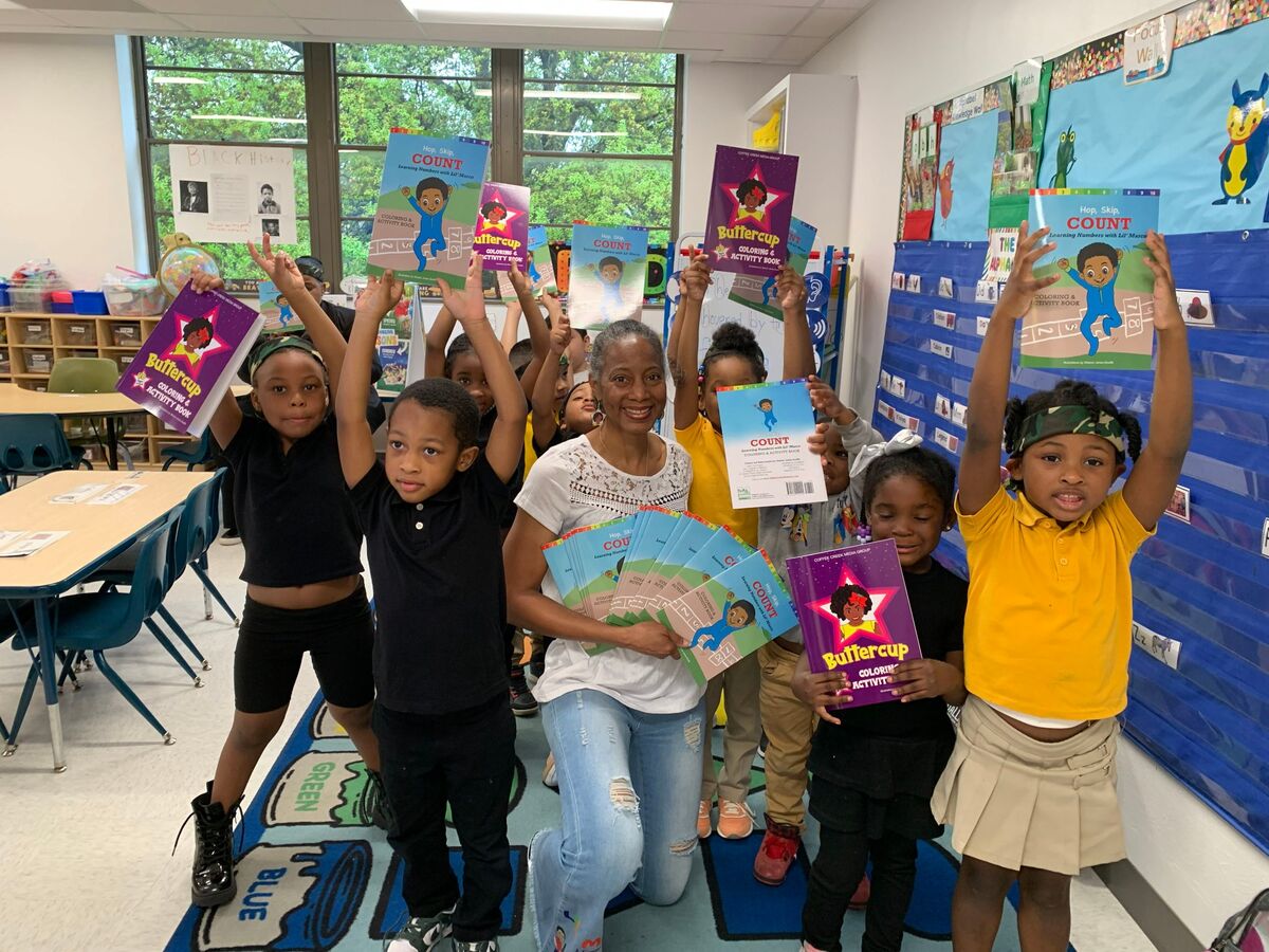 Adelle Turner Elementary School students cheering and holding up their new activity books