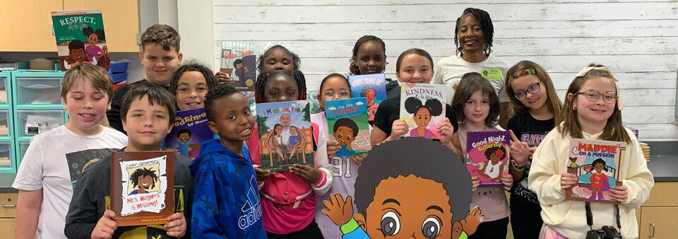 Students proudly holding their new books